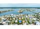 Aerial view showcasing a house and neighborhood near the water at 16202 3Rd St E, Redington Beach, FL 33708