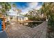 Backyard pool with surrounding debris and damaged landscaping at 16202 3Rd St E, Redington Beach, FL 33708