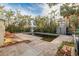 Backyard pool with surrounding debris and damaged landscaping at 16202 3Rd St E, Redington Beach, FL 33708