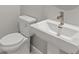 Close-up view of a half-bath with white fixtures and modern faucet at 18424 Vista Park Ter, Venice, FL 34293