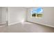 The spacious bedroom is enhanced by cool-toned tile flooring and a large window with a scenic view at 18424 Vista Park Ter, Venice, FL 34293