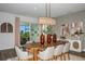 Bright dining room with oval wood table and access to a lanai at 18424 Vista Park Ter, Venice, FL 34293