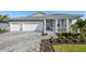 Beautiful single-Gathering home with a welcoming front porch and a well-manicured, landscaped yard at 18424 Vista Park Ter, Venice, FL 34293