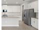 Bright kitchen featuring modern stainless steel appliances and ample white cabinetry at 18424 Vista Park Ter, Venice, FL 34293