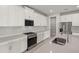 Stylish kitchen showcasing stainless steel appliances, an island, and sleek white cabinetry at 18424 Vista Park Ter, Venice, FL 34293