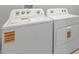 Modern laundry room featuring a white Whirlpool washer and dryer at 18424 Vista Park Ter, Venice, FL 34293