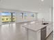 Open-concept space showcasing a spacious living room connected to the kitchen and patio at 18424 Vista Park Ter, Venice, FL 34293
