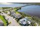 Aerial view of waterfront community with pool, clubhouse, and townhomes at 2113 Sunset Wind Loop, Oldsmar, FL 34677