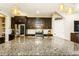 Large kitchen island with granite countertop and seating at 2113 Sunset Wind Loop, Oldsmar, FL 34677
