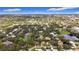 Wide aerial perspective of a residential area surrounded by mature trees and a tranquil pond at 2358 Havana Dr, Clearwater, FL 33764