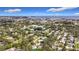 Expansive aerial view showcasing a residential neighborhood with lush greenery and a nearby lake at 2358 Havana Dr, Clearwater, FL 33764