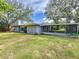 House backyard view with covered patio and fenced yard at 2358 Havana Dr, Clearwater, FL 33764
