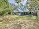 Spacious backyard with a large screened patio and mature trees at 2358 Havana Dr, Clearwater, FL 33764