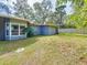House backyard view with covered patio and fenced yard at 2358 Havana Dr, Clearwater, FL 33764