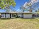 House backyard view with covered patio and fenced yard at 2358 Havana Dr, Clearwater, FL 33764