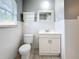Clean bathroom with white vanity, toilet, and tiled walls at 2358 Havana Dr, Clearwater, FL 33764