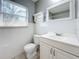 Bathroom with a vanity, toilet, and window at 2358 Havana Dr, Clearwater, FL 33764