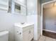 Bright bathroom featuring a white vanity and tiled shower at 2358 Havana Dr, Clearwater, FL 33764