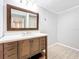 Bathroom with wood vanity, white countertop, and tiled floor at 2358 Havana Dr, Clearwater, FL 33764