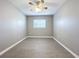 Spacious bedroom with ceiling fan and wood-look flooring at 2358 Havana Dr, Clearwater, FL 33764