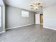 Bright bedroom with gray walls, wood-look floors, and ceiling fan at 2358 Havana Dr, Clearwater, FL 33764