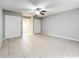 Spacious bedroom with tile floors, ceiling fan, and double closets at 2358 Havana Dr, Clearwater, FL 33764