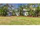 Newly renovated home with a blue door and lush tropical landscaping at 2358 Havana Dr, Clearwater, FL 33764