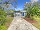Well-maintained home with a blue door and attractive landscaping at 2358 Havana Dr, Clearwater, FL 33764