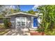 Updated home featuring a welcoming blue door and well-maintained landscaping at 2358 Havana Dr, Clearwater, FL 33764
