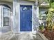 Inviting blue front door adds a pop of color to the home's facade at 2358 Havana Dr, Clearwater, FL 33764