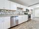 Modern kitchen with stainless steel appliances and white cabinets at 2358 Havana Dr, Clearwater, FL 33764