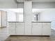 White kitchen cabinets with granite countertops and an island at 2358 Havana Dr, Clearwater, FL 33764
