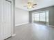 Living room featuring gray walls, wood-look vinyl flooring and a ceiling fan at 2358 Havana Dr, Clearwater, FL 33764