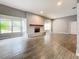 Open living room with tile floors and a fireplace at 2358 Havana Dr, Clearwater, FL 33764