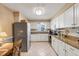 Kitchen with granite countertops and white cabinets at 3281 Mcmath Dr, Palm Harbor, FL 34684