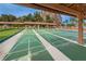 Multiple shuffleboard courts with clear markings under a roof at 4993 Bostonian Loop # 4993, New Port Richey, FL 34655