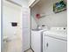 Laundry closet with washer, dryer and shelving at 5108 Cactus Needle Ln, Wesley Chapel, FL 33544