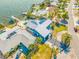 Aerial view of waterfront home with a metal roof and solar panels at 596 Belle Point Dr, St Pete Beach, FL 33706