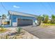 Modern home with attached garage and stone accents at 596 Belle Point Dr, St Pete Beach, FL 33706