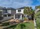 Backyard featuring a fire pit, lounge seating, mature palm trees and solar panels on the roof at 8916 Arabella Ln, Seminole, FL 33777