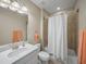 Bright bathroom with neutral tile, tub shower combo, and modern fixtures at 8916 Arabella Ln, Seminole, FL 33777