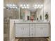 Bathroom with double vanity, granite countertop and glass shower at 8916 Arabella Ln, Seminole, FL 33777