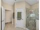 Bathroom featuring a glass-enclosed shower stall, and an adjoining water closet with linen closet at 8916 Arabella Ln, Seminole, FL 33777
