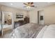 Comfortable bedroom with ceiling fan, television, and easy access to the living area and bathroom at 8916 Arabella Ln, Seminole, FL 33777