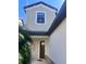 Close up of a home's front entrance with a dark door, trimmed with stone, and nice architectural details at 8916 Arabella Ln, Seminole, FL 33777