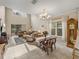Inviting living room with soaring ceilings, tile floors, and large windows at 8916 Arabella Ln, Seminole, FL 33777