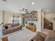 Comfortable living room with bookshelves and a ceiling fan for added circulation at 8916 Arabella Ln, Seminole, FL 33777