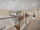 Upstairs loft area featuring a comfortable seating area, built-in shelving, and ample natural light at 8916 Arabella Ln, Seminole, FL 33777
