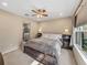 Cozy main bedroom with soft carpet, a ceiling fan, and an en-suite bathroom at 8916 Arabella Ln, Seminole, FL 33777