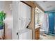 Bright bathroom featuring a stackable washer and dryer, vanity, and tiled shower at 9415 Blind Pass Rd # 905, St Pete Beach, FL 33706